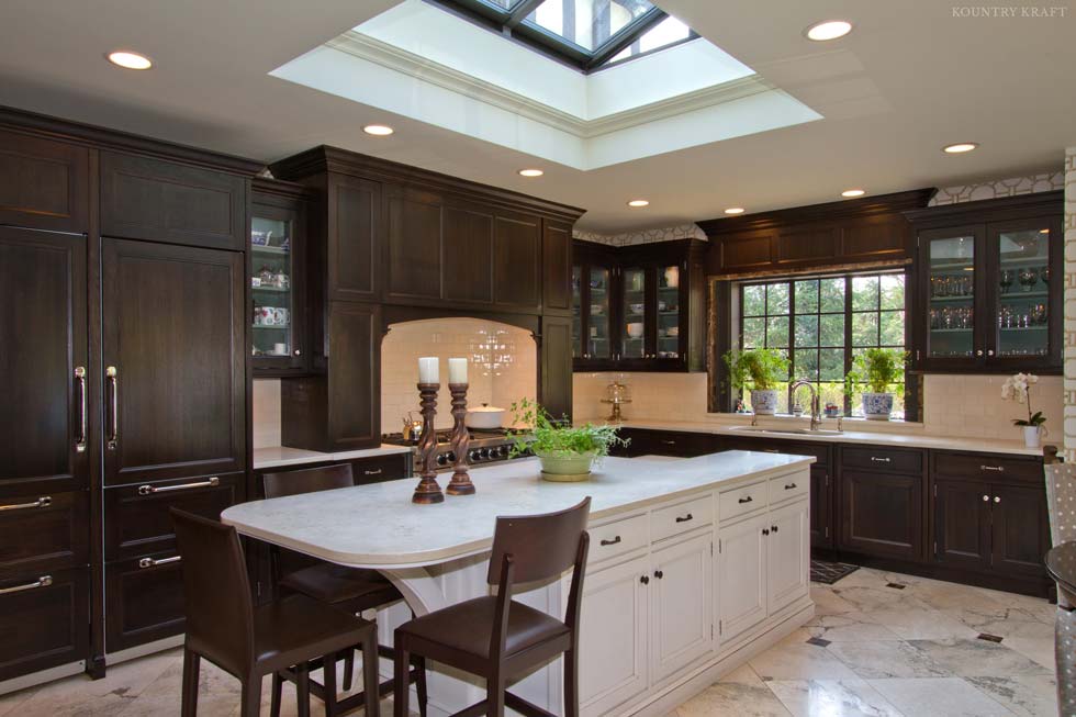 Dark cabinets, white island with three chairs, range, and skylight North Haledon, NJ