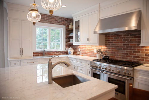 Kitchen with brick walls, island, and range Madison, NJ