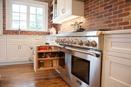Range and cabinetry featuring a pull out spice rack Madison, NJ