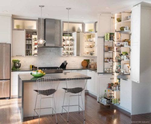 Custom cabinet storage ideas visibly shown in a large white kitchen designed by kessebohmer