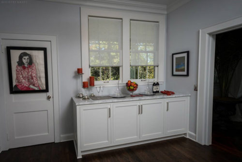 White cabinetry under window with marble countertop Laurel Hollow, NY