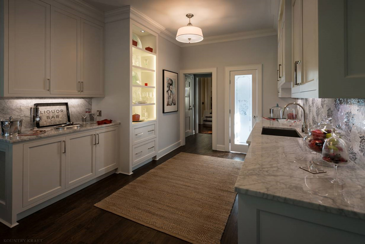 White cabinetry, counter with sink, and liquor bar Laurel Hollow, NY