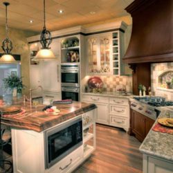 Custom kitchen cabinetry, island with built in microwave, and elegant range