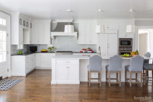 White Chantilly Lace Cabinets for a traditional Pennsylvania kitchen with wood floors and large island