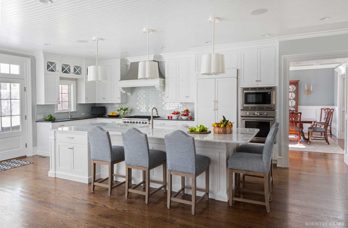 Kitchen featuring island with five chairs, oven, range, and Chantilly Lace Cabinets Villanova, PA