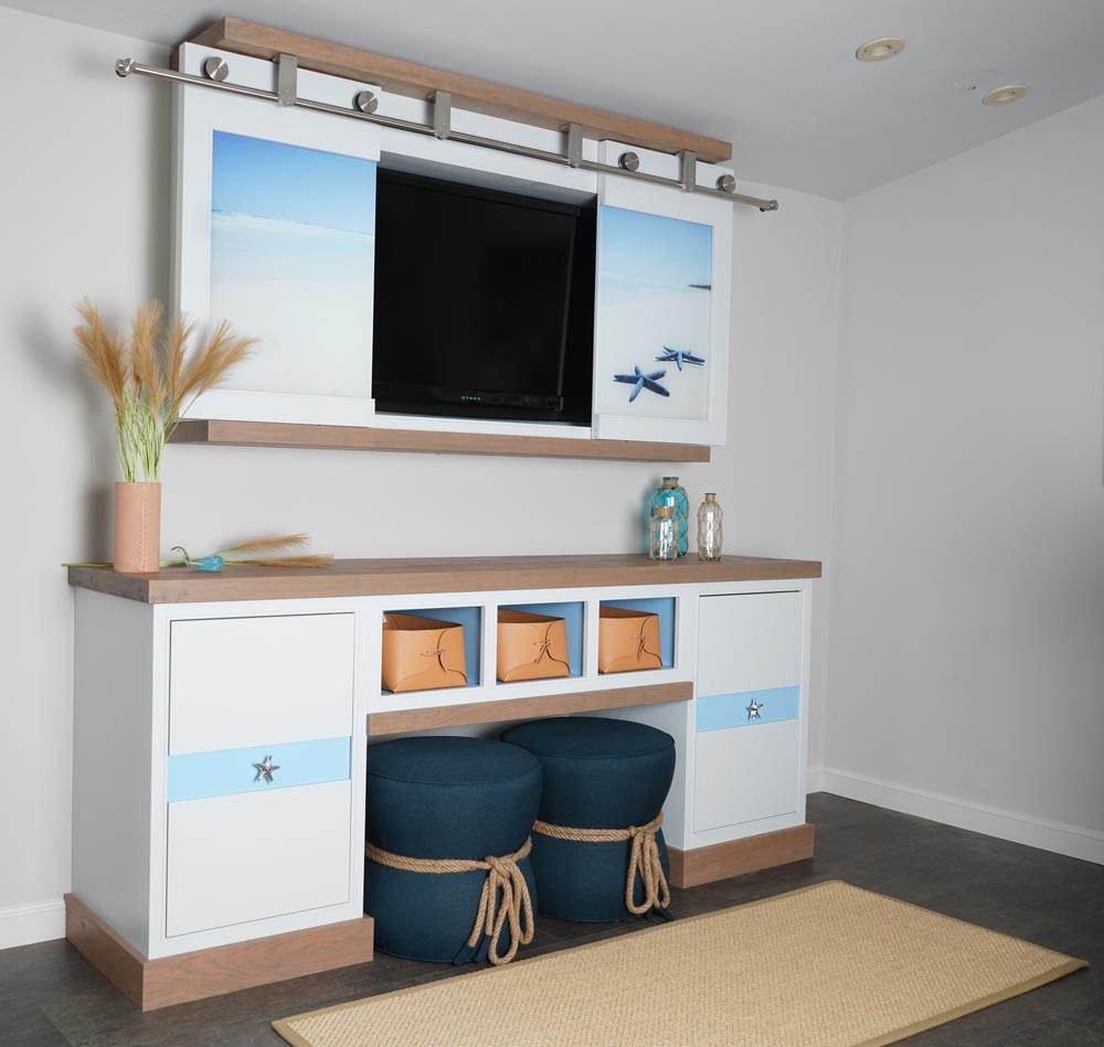 Sliding doors and hidden shelf in beachy entertainment center