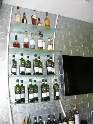 Contemporary bar with open glass wine shelves and flat screen Malvern, PA