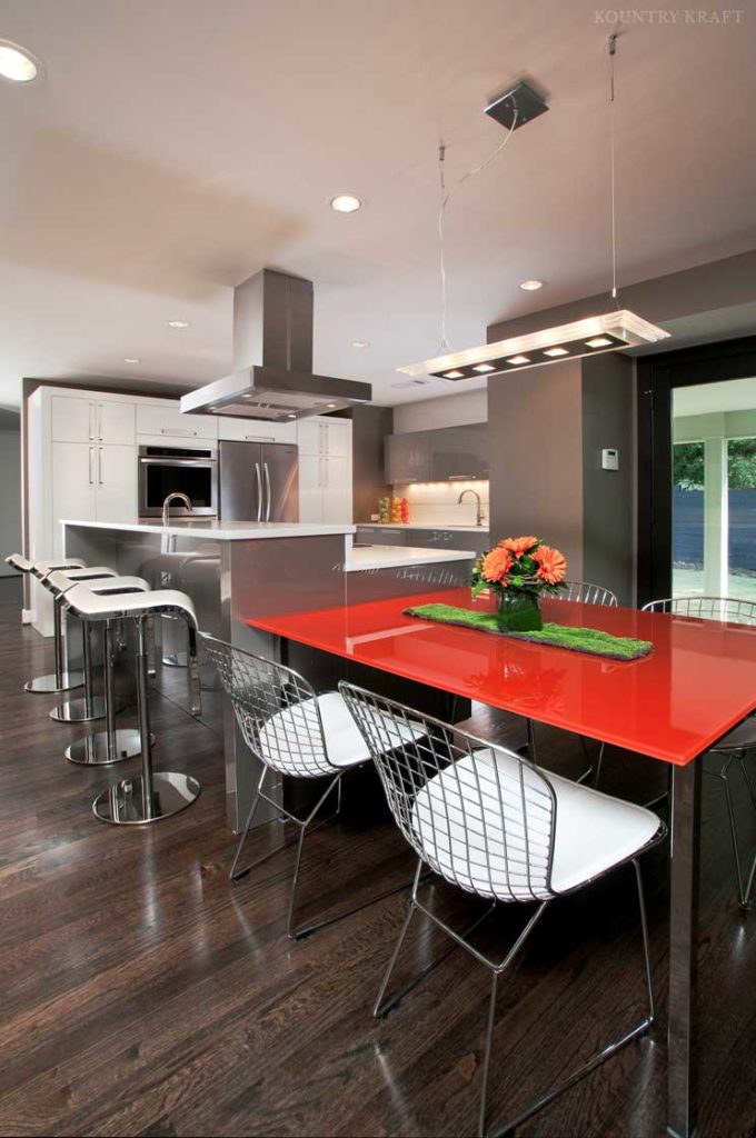 Contemporary kitchen with multilevel island, red table, and seats Norcross, GA