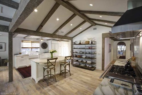 Country kitchen with small island and seating, shelves counters, and range Montecito, CA