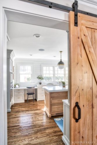 This Farmhouse Kitchen Design Style With Coventry Gray Kitchen Cabinets Features Hanging Barn Doors