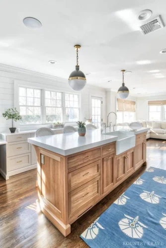 Rift Cut White Oak Kitchen Island Cabinets with Brass Hardware and Pendant Lights in Chatham, New Jersey