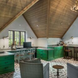 Wide view of craft room and home office with custom cabinets in Haverford PA, featuring green cabinetry, patterned tile, and vaulted wood ceiling.