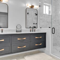 Modern master bathroom with custom bathroom cabinets in Sea Isle City NJ featuring dark painted cabinetry and marble finishes