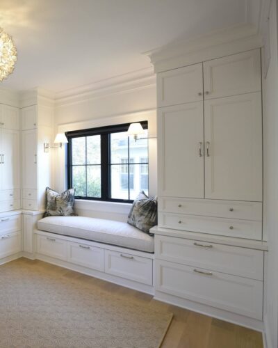 Window seat with deep drawer storage and tall cabinet; custom bedroom cabinets in Annapolis MD.