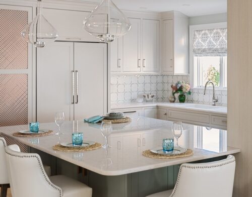 Custom kitchen cabinets in Massachusetts with marble countertops, Balboa Mist perimeter cabinetry, and patterned backsplash.