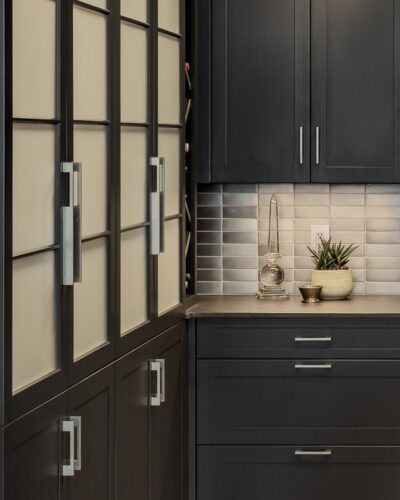 Close-up of custom cabinetry in Exeter NH with frosted glass pantry doors, modern hardware, and maple construction.