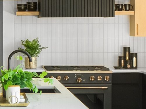 Custom kitchen cabinets Knoxville TN – close-up of backsplash with vertical white tile and black cabinetry.