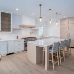 Full Avalon NJ kitchen remodel showcasing custom cabinetry by Kountry Kraft, quartz island, Thermador appliances, and brass fixtures.