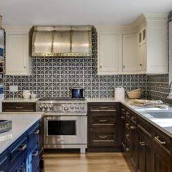 Beautiful custom kitchen cabinets in Exeter NH featuring a navy island, white uppers, and walnut base cabinetry by Kountry Kraft.