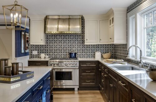 Beautiful custom kitchen cabinets in Exeter NH featuring a navy island, white uppers, and walnut base cabinetry by Kountry Kraft.