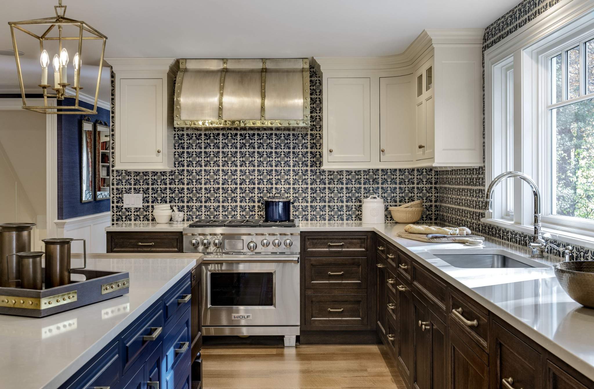 Beautiful custom kitchen cabinets in Exeter NH featuring a navy island, white uppers, and walnut base cabinetry by Kountry Kraft.