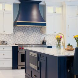 Custom kitchen cabinets in Nesconset NY with navy island, white perimeter, and marble countertops.