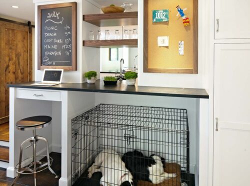 Built-in desk and pet-friendly nook with dog crate, walnut shelves, and command center in custom New Canaan kitchen.