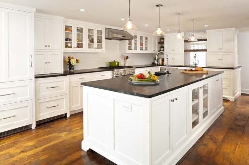 New Canaan CT kitchen remodel with custom white shaker cabinets, large island, pendant lights, and soapstone countertops.
