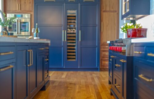 Kitchen remodel in Annapolis Maryland featuring custom cabinetry, walnut accents, and navy finishes by Kountry Kraft and Chroma Kitchens.