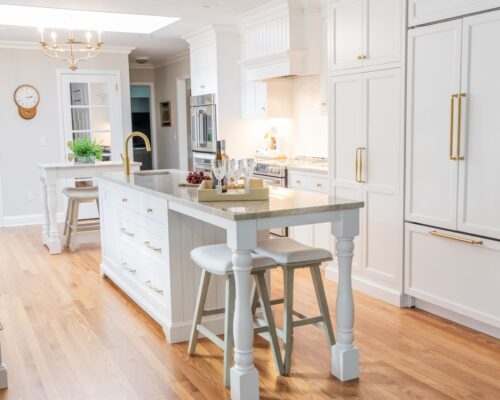 White kitchen remodel Cheshire CT with dual islands, custom cabinetry, and Taj Mahal quartzite for timeless style and function.