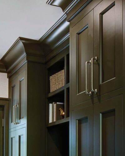 Open cubbies beside tall inset doors with Blum hinges and woven basket—custom mudroom cabinets in Mendham, NJ by Wydian Kitchens.