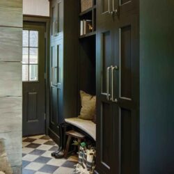 Checkerboard tile entry with limestone bench and floor-to-ceiling inset cabinets—custom mudroom cabinets in Mendham, NJ.