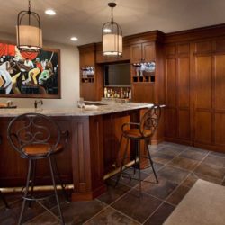 Full view of bar with three seats, cabinets, and painting in background Ellicott City, MD