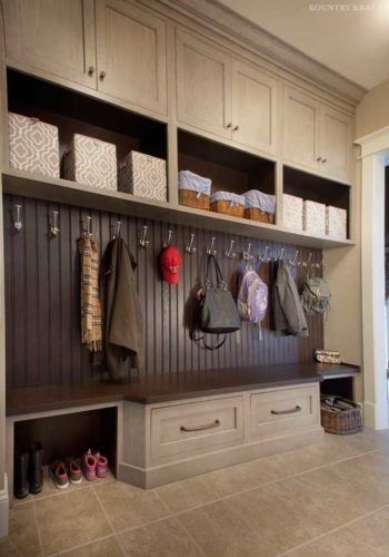 this mudroom is a custom closet featuring cabinets and shelves to achieve optimal amount of space