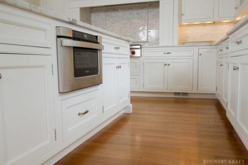 White painted traditional kitchen and island with built-in microwave drawer North Haledon, NJ