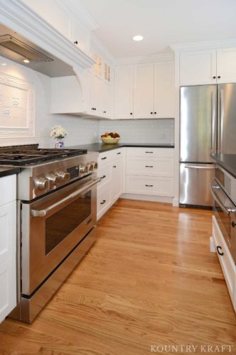 Range and refrigerator with white custom kitchen cabinets Short Hills, NJ