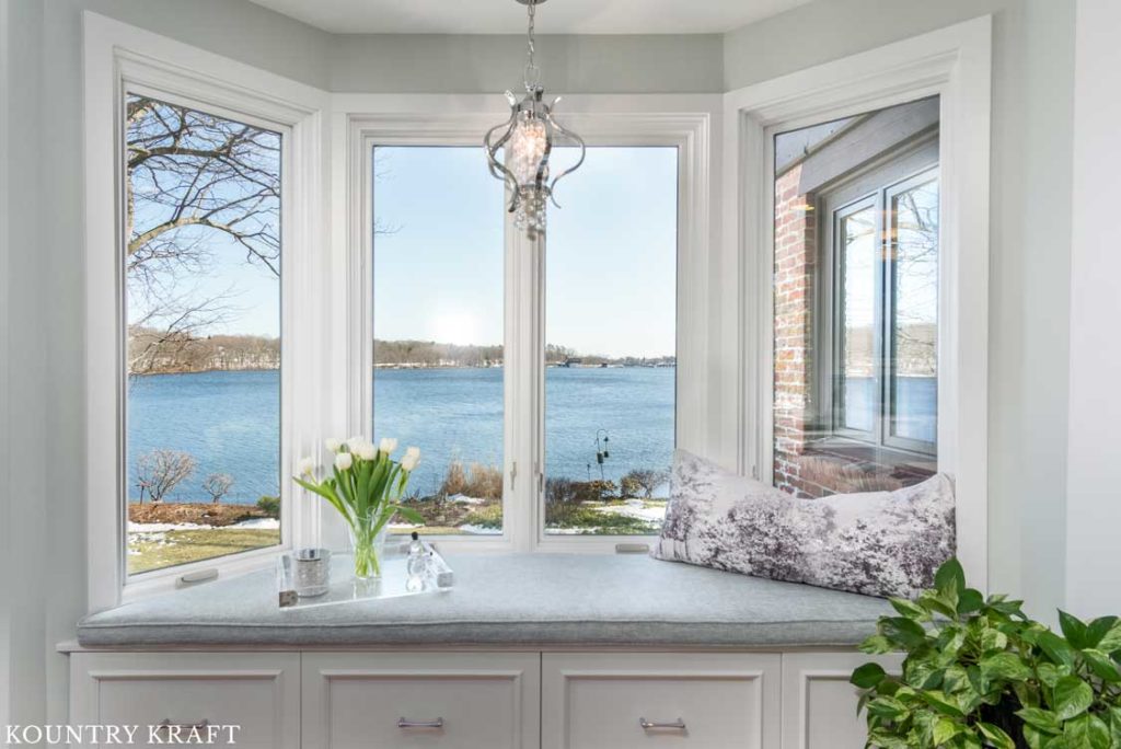 Built-in window bench custom painted Decorators White to match the vanity in a master bath located in Winchster, Massachusetts,