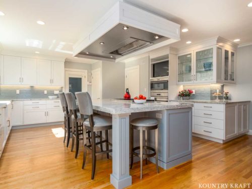 Decorators White Cabinets and Benjamin Moore Shadow Gray Kitchen Island for a home located in Marblehead, Massachusetts