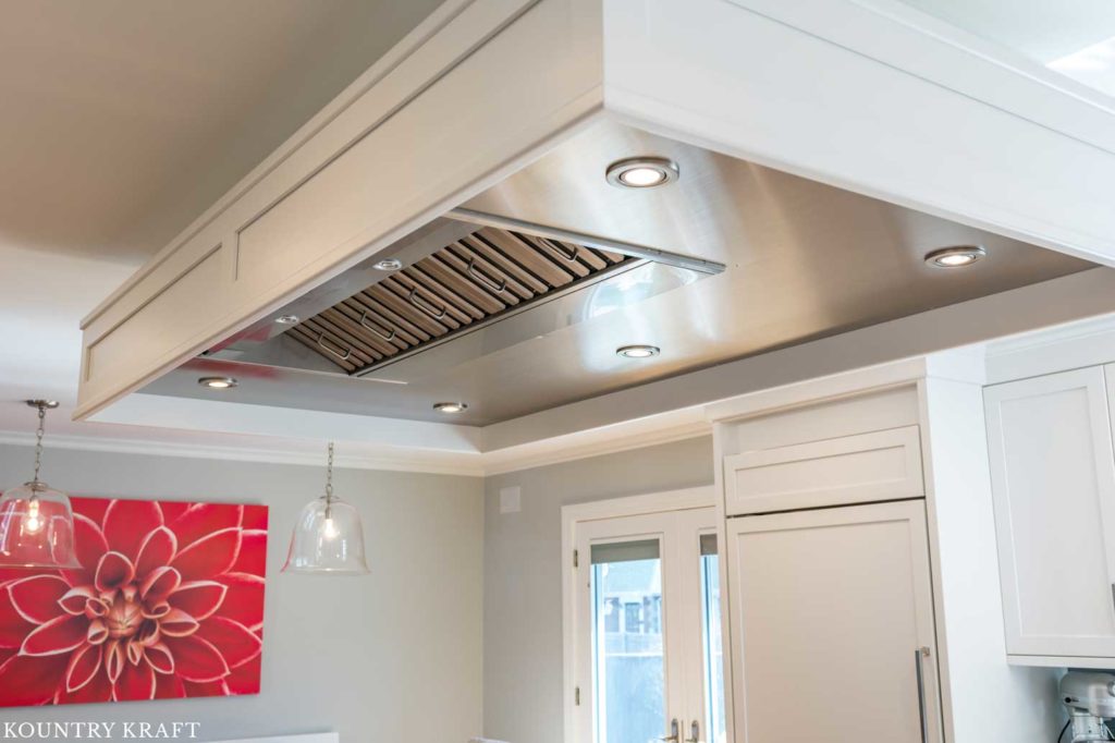 Custom Decorators White Range Hood with Stainless Steel Insert for a kitchen in Marblehead, Massachusetts