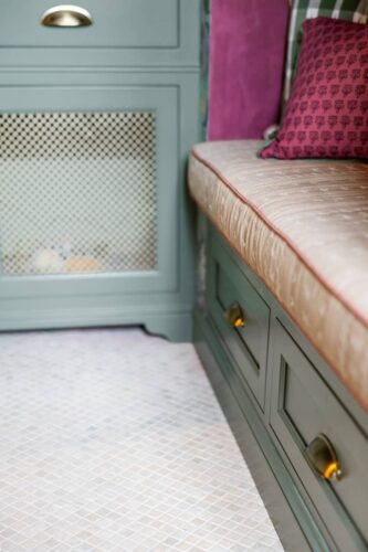 Close-up of bench seat cushion and cabinetry hardware in the Designer Show House mudroom kitchen.