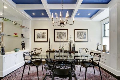 This Custom Entertainment Area is an Open Concept Dining Room Featuring Glass Shelving and Custom Cabinets