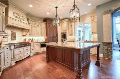 These Century Vanilla Bean Cabinets with Distressed Finish Features A Traditional Design Style For This Kitchen