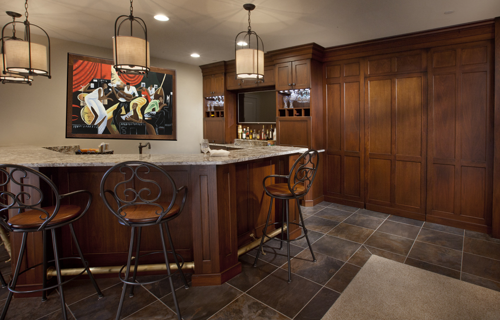A luxury dining room bar cabinet in Ellicott City, MD crafted from rich Lyptus wood featuring stemware racks and a hidden door.