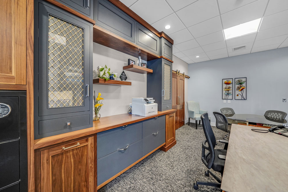 Custom office cabinets with mesh door inserts and floating shelves