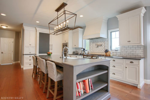 Extra White Kitchen Cabinets with Gray Kitchen Island for farmhouse style home in Sinking Spring, Pennsylvania
