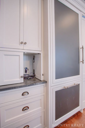 Hidden Outlets Camouflaged in a Charging Station in Extra White Kitchen Cabinets