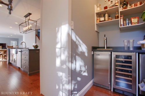 Hidden beverage center in the pantry off the kitchen with stainless steel wine and beer fridge