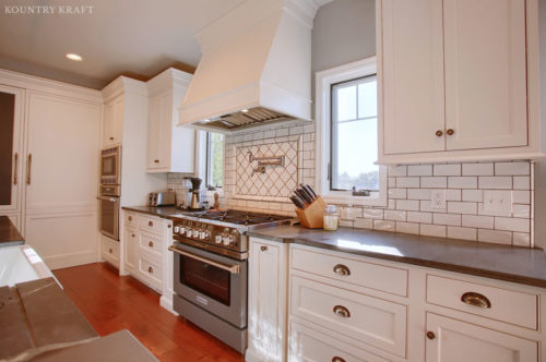 Extra White Kitchen Cabinets with matching custom range hood and subway tile backsplash Sinking Spring, Pennsylvania