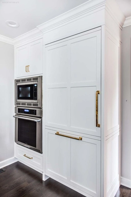 Stainless steel appliances and fully integrated white fridge in Summit, NJ
