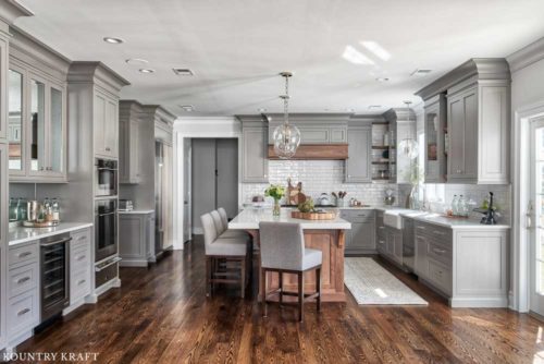 Coventry Gray Kitchen Cabinets and Rift Cut White Oak Kitchen Island Features A Transitional Design Style